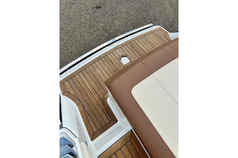 Slide: The Image of 2010 Cobalt 276 boat with teak deck and brown seating. - 30