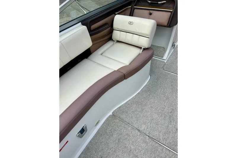Slide: The Image of 2010 Cobalt 276 boat interior with beige and brown seating. - 31