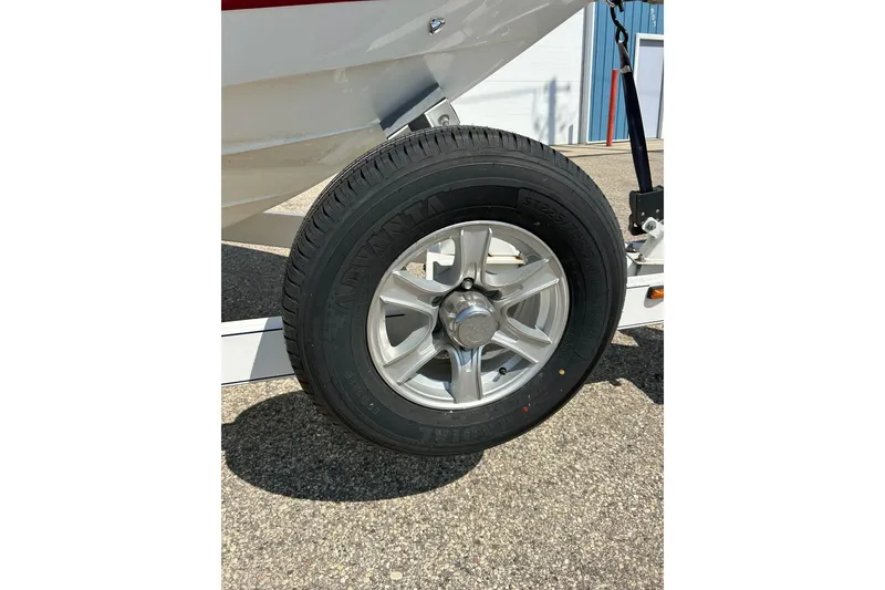 Slide: The Image of Trailer wheel of a 2010 Cobalt 276 boat on pavement. - 34