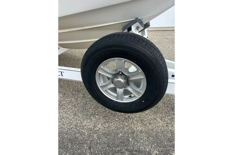 Slide: The Image of Trailer wheel of a 2010 Cobalt 276 boat on pavement. - 5