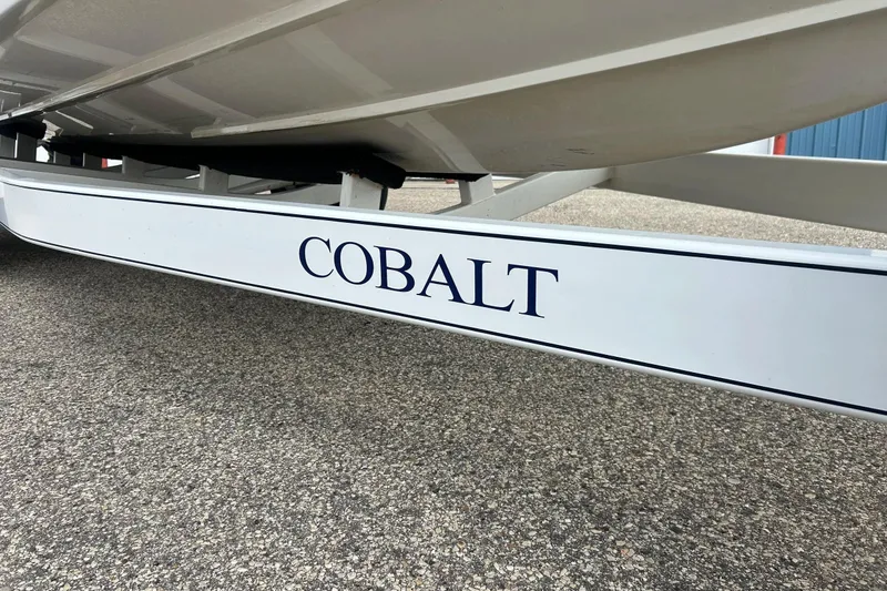 Slide: The Image of 2010 Cobalt 276 boat trailer on pavement, showcasing brand logo. - 6