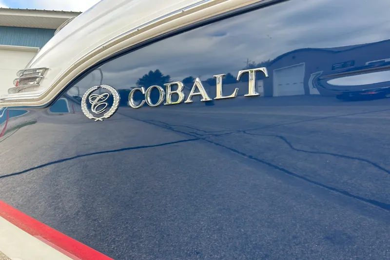 Slide: The Image of 2010 Cobalt 276 boat with logo on sleek blue exterior. - 8