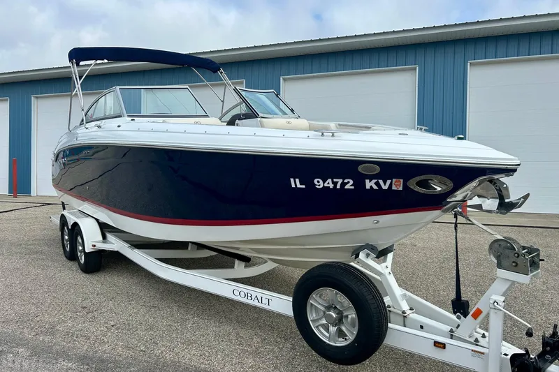Slide: The Image of 2010 Cobalt 276 boat on trailer, parked outside blue storage facility. - 9