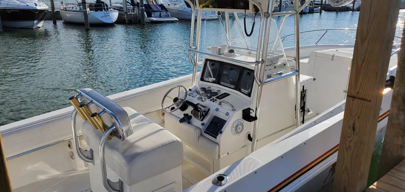 Slide: The Image of 1996 Fountain 31 Tournament Edition boat on trailer in marina parking lot. - 10