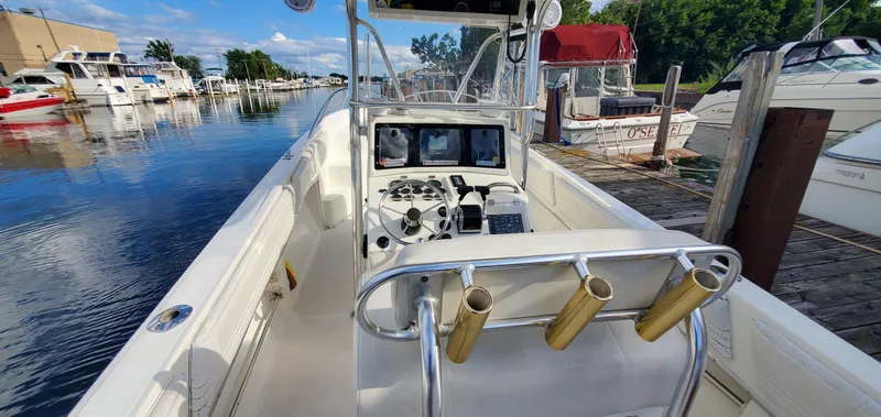 Slide: The Image of Twin Mercury outboard engines on a 1996 Fountain 31 Tournament Edition boat at a marina. - 11