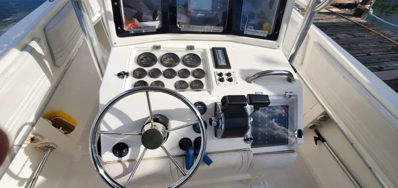 Slide: The Image of 1996 Fountain 31 Tournament Edition boat with dual Mercury engines at a marina. - 12