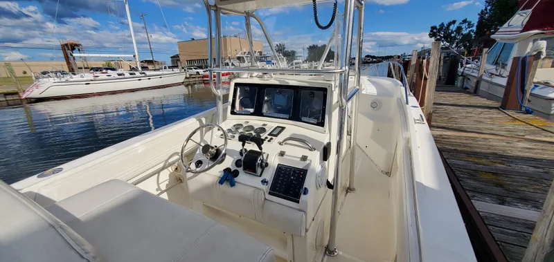 Slide: The Image of 1996 Fountain 31 Tournament Edition boat interior with seating and rod holders. - 13