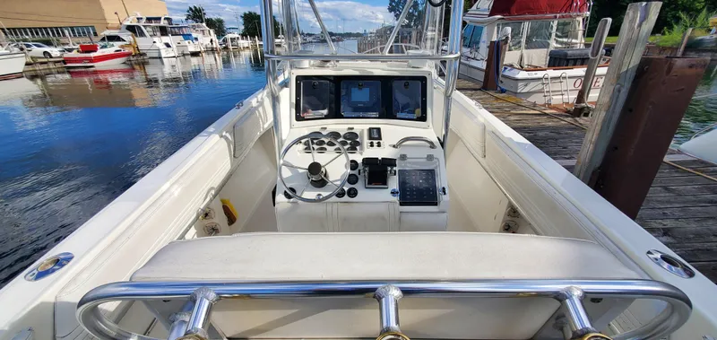 Slide: The Image of 1996 Fountain 31 Tournament Edition boat interior with steering wheel and rod holders. - 14