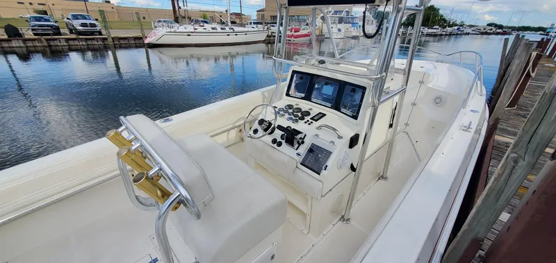 Slide: The Image of 1996 Fountain 31 Tournament Edition boat dashboard with steering wheel and controls. - 16