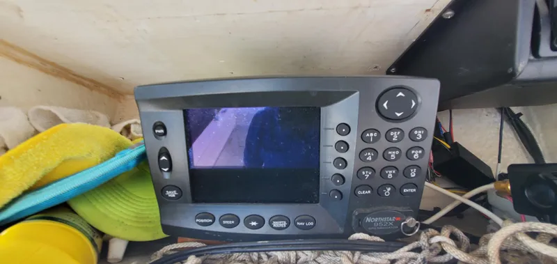 Slide: The Image of 1996 Fountain 31 Tournament Edition boat console with steering wheel and navigation equipment. - 17