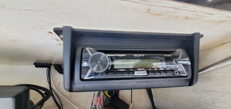 Slide: The Image of 1996 Fountain 31 Tournament Edition boat cockpit with steering wheel and control panel. - 18