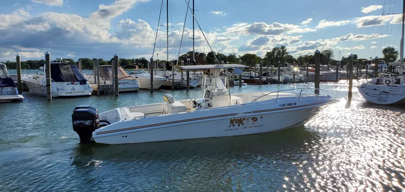 Slide: The Image of 1996 Fountain 31 Tournament Edition boat on trailer in parking lot. - 2
