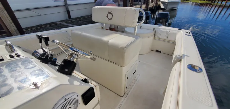 Slide: The Image of 1996 Fountain 31 Tournament Edition boat interior with helm and seating at marina. - 22