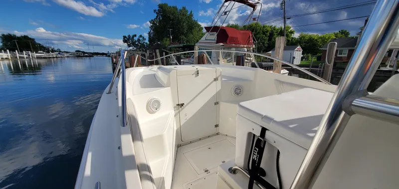 Slide: The Image of 1996 Fountain 31 Tournament Edition boat interior with white seating and steering wheel. - 23