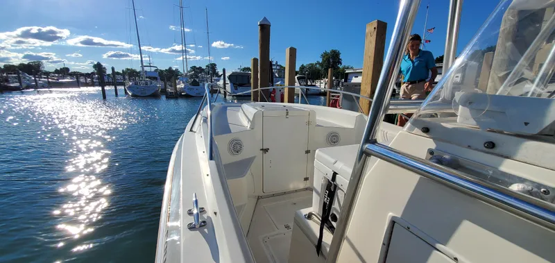 Slide: The Image of 1996 Fountain 31 Tournament Edition boat interior with white seating and stainless steel fixtures. - 24