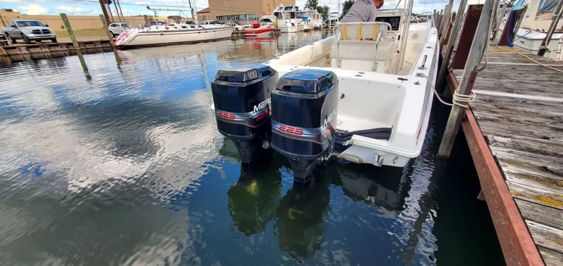 Slide: The Image of 1996 Fountain 31 Tournament Edition boat docked at a marina with clear blue skies. - 29