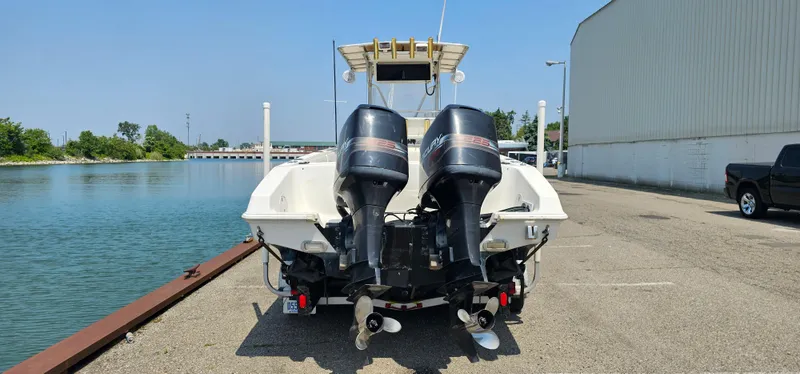 Slide: The Image of 1996 Fountain 31 Tournament Edition boat with T-top and rod holders in a parking lot. - 33