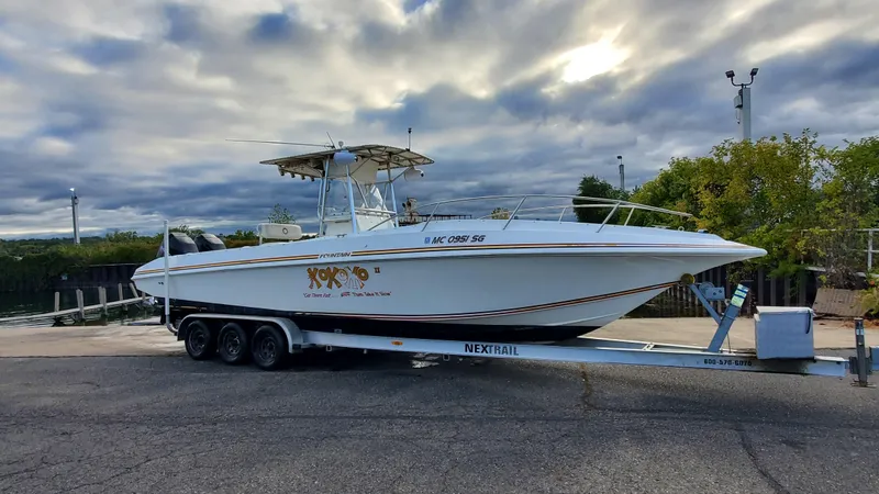 Slide: The Image of 1996 Fountain 31 Tournament Edition boat interior with steering console and rod holders. - 35