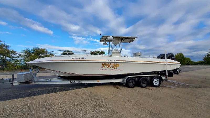 Slide: The Image of Interior cabin of a 1996 Fountain 31 Tournament Edition boat, featuring cushioned seating. - 36
