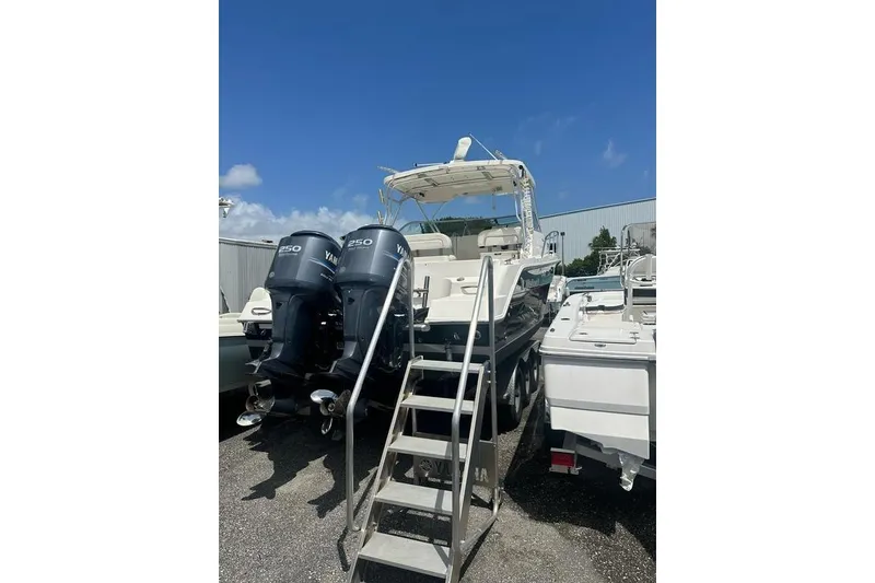 Slide: The Image of 2010 Wellcraft 290 Coastal Walk-Around boat with twin Yamaha 250 engines, docked outdoors. - 4