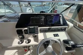 Slide: The Image of 2010 Wellcraft 290 Coastal Walk-Around helm with modern navigation equipment and controls. - 6