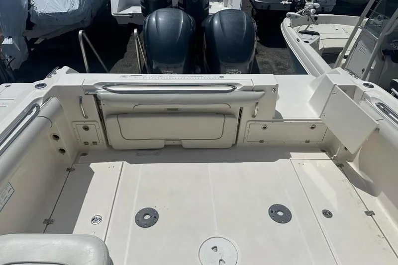 Slide: The Image of 2010 Wellcraft 290 Coastal Walk-Around boat interior with dual engines and spacious deck. - 9