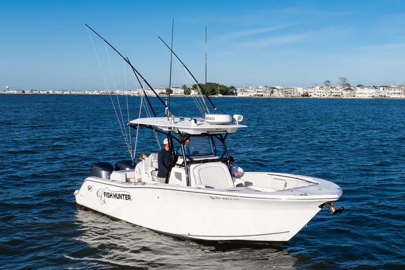 The Image of 2021 Sea Fox 288 Commander boat on water, equipped for fishing, with coastal background. - 1