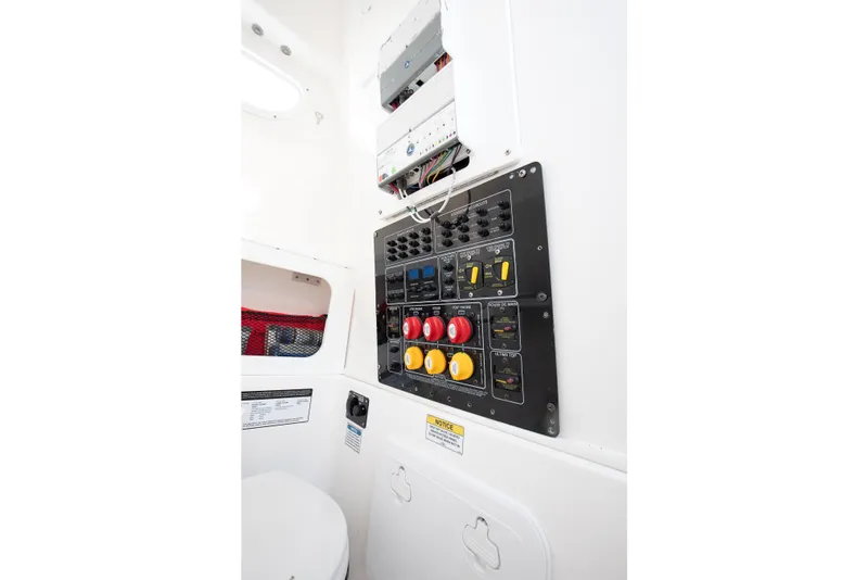 Slide: The Image of Control panel inside 2021 Sea Fox 288 Commander boat, featuring switches and wiring. - 11