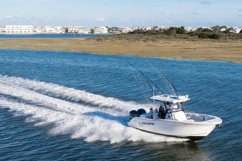 Slide: The Image of 2021 Sea Fox 288 Commander boat cruising on a scenic coastal waterway. - 13
