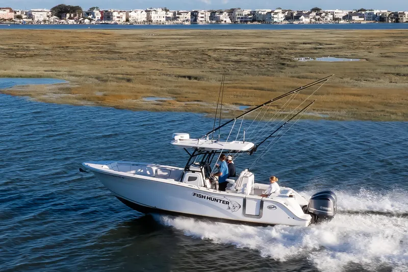 Slide: The Image of 2021 Sea Fox 288 Commander boat cruising on water near coastal homes. - 15