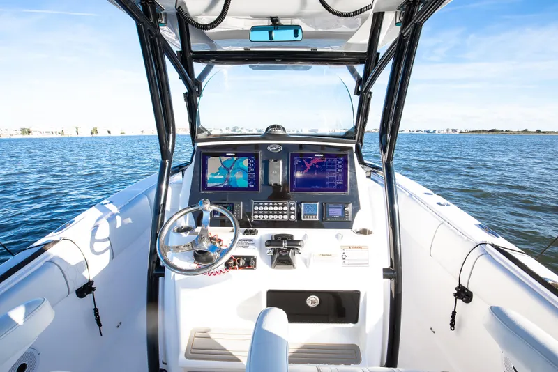 Slide: The Image of 2021 Sea Fox 288 Commander boat dashboard with navigation screens on open water. - 4