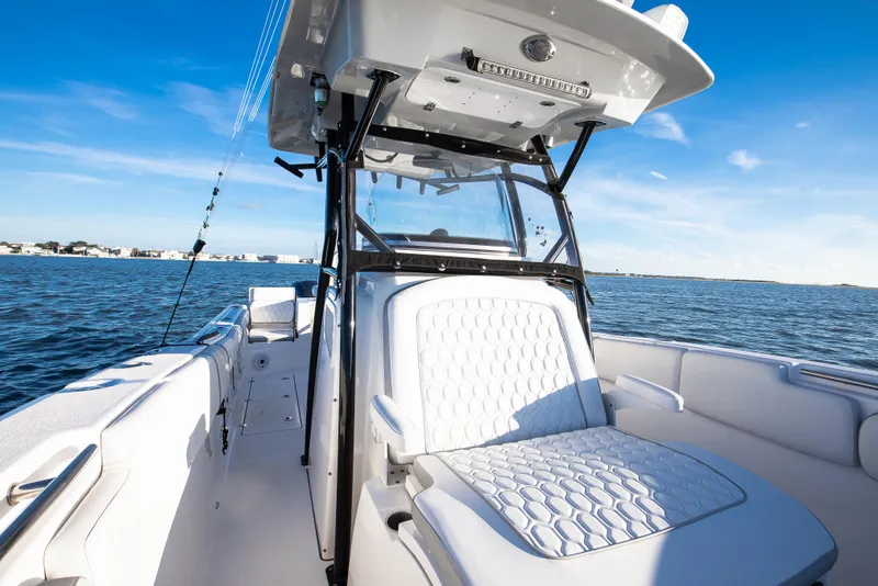 Slide: The Image of 2021 Sea Fox 288 Commander boat interior with white seating on open water. - 7