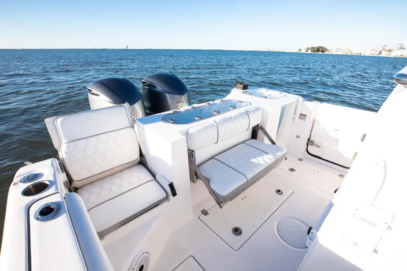 Slide: The Image of 2021 Sea Fox 288 Commander boat interior with seating and dual engines on open water. - 9