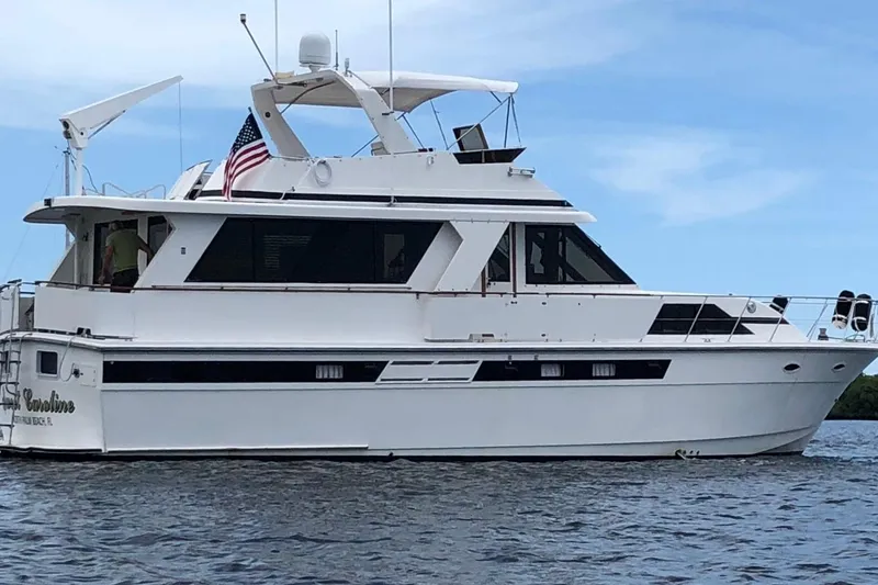 The Image of 1989 Jefferson Marquessa 52 yacht on water, featuring sleek design and American flag. - 0