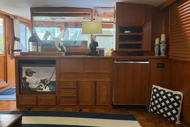 Slide: The Image of 1989 Jefferson Marquessa 52 yacht interior with wooden cabinetry, nautical decor, and a cozy ambiance. - 12