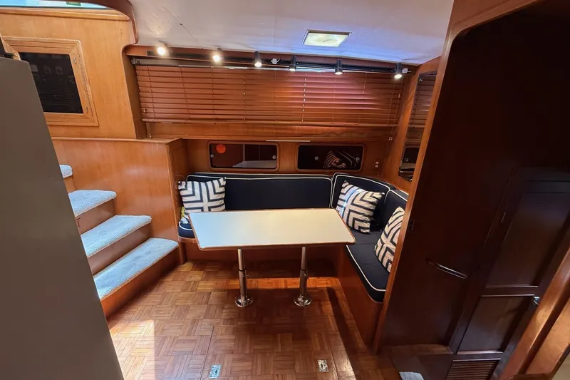 Slide: The Image of Interior of 1989 Jefferson Marquessa 52 yacht with cozy dining area and wooden accents. - 16