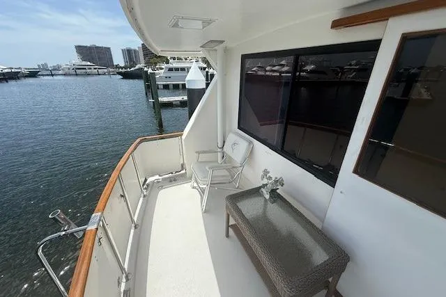 Slide: The Image of 1989 Jefferson Marquessa 52 yacht deck with seating, overlooking marina waters. - 2