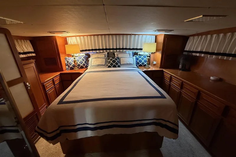 Slide: The Image of Luxurious bedroom interior of 1989 Jefferson Marquessa 52 yacht with elegant bedding and wood cabinetry. - 22