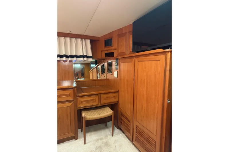 Slide: The Image of 1989 Jefferson Marquessa 52 yacht interior with wooden cabinetry and a small desk area. - 23