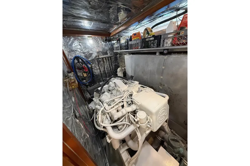 Slide: The Image of Engine room of 1989 Jefferson Marquessa 52 yacht, showcasing mechanical components and storage. - 29