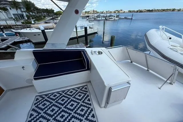 Slide: The Image of 1989 Jefferson Marquessa 52 yacht deck with seating, patterned rug, and waterfront view. - 6