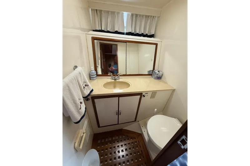 Slide: The Image of Bathroom interior of 1989 Jefferson Marquessa 52 yacht with sink, mirror, and toilet. - 18