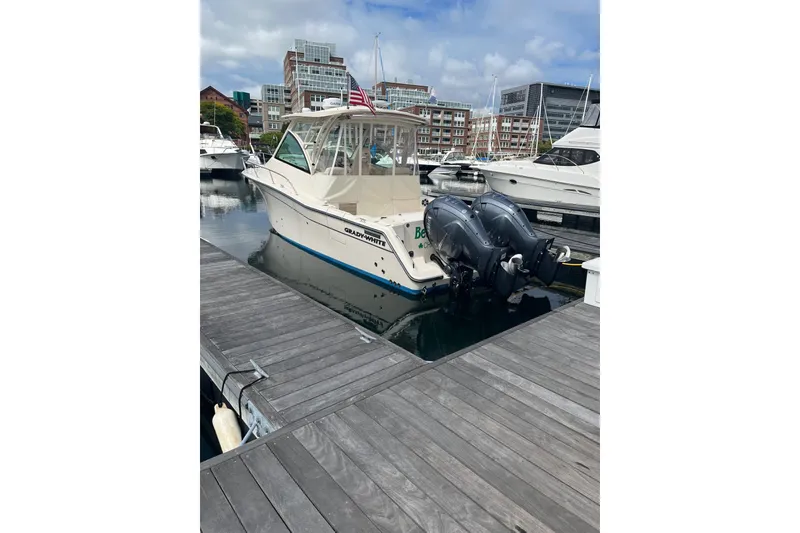 The Image of 2020 Grady-White Express 330 boat docked at marina with twin engines. - 0