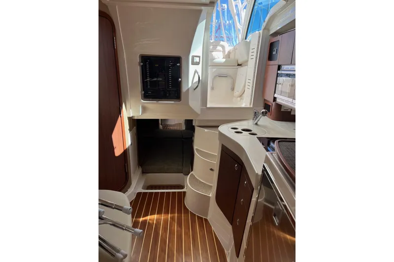Slide: The Image of Interior of 2020 Grady-White Express 330 boat, featuring modern cabinetry and wood flooring. - 15