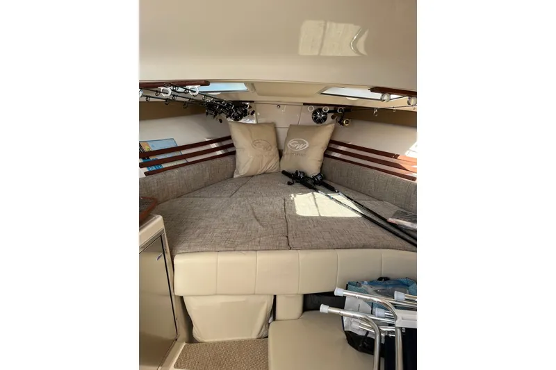 Slide: The Image of 2020 Grady-White Express 330 cabin interior with fishing rods and cushions. - 17