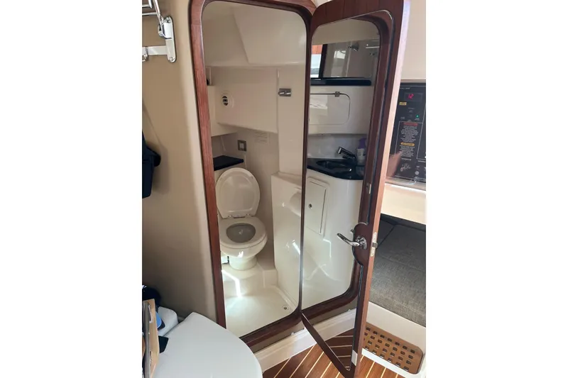 Slide: The Image of 2020 Grady-White Express 330 boat interior bathroom with toilet and sink. - 20