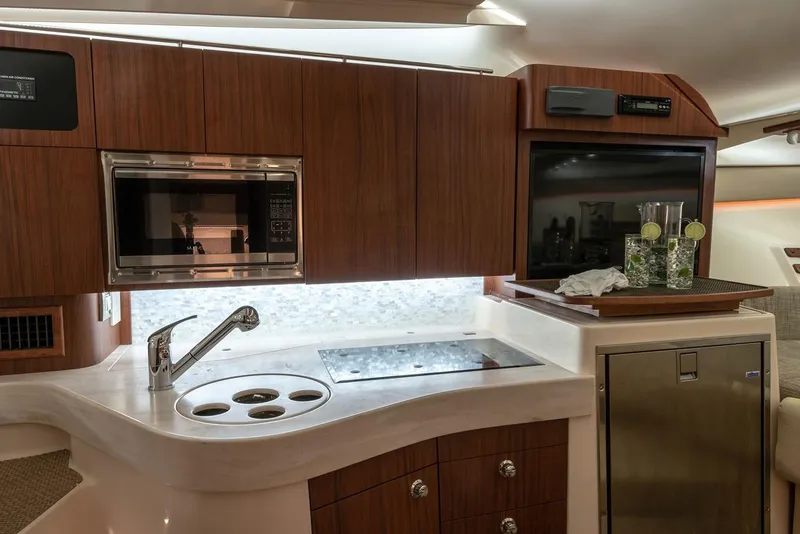 Slide: The Image of Manufacturer Provided Image: Modern kitchen area in 2020 Grady-White Express 330 boat with microwave and sink. - 24