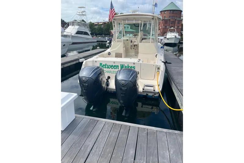 Slide: The Image of 2020 Grady-White Express 330 boat docked with twin outboard engines. - 3
