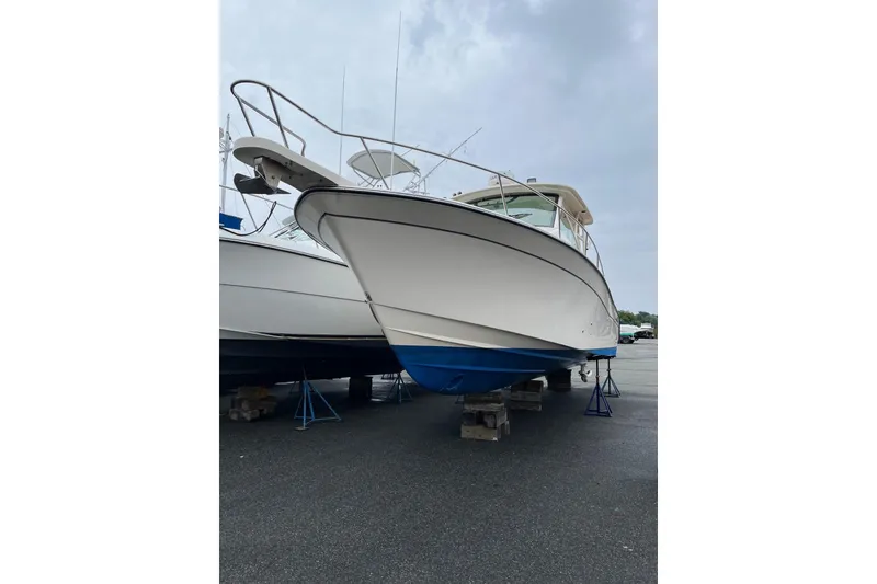 Slide: The Image of 2020 Grady-White Express 330 boat on stands, viewed from the front. - 6