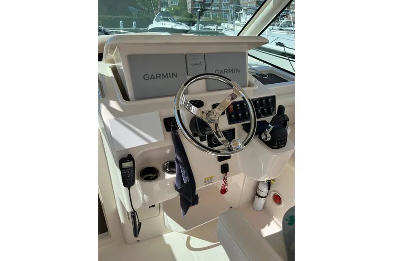Slide: The Image of Helm of 2020 Grady-White Express 330 with Garmin navigation system and controls. - 9